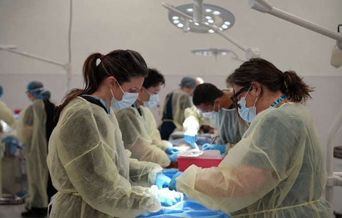 Surgical team around blue drape